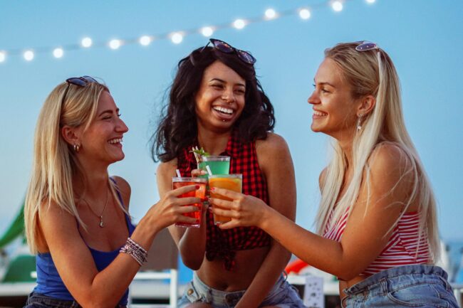 Young girls having a party in a beach – Teenagers drinking cockt